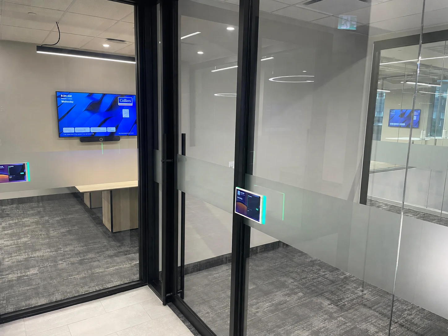 345 King Suite 200 black-framed glass meeting rooms and finished corridor, with reflections removed for privacy